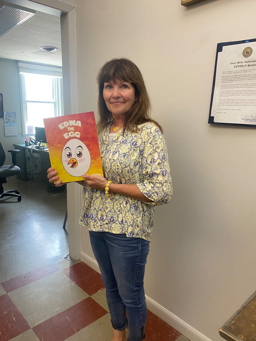 Kim Feliciano holds up a copy of her new children’s book “Edna the Egg.” The book is available for purchase on Amazon and Barnes and Noble’s website.